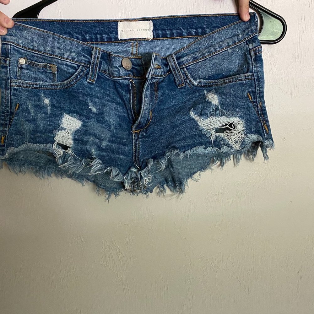 Gilded Intent Low Rise Distressed Denim Shorts